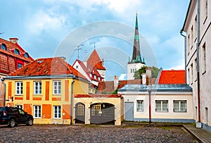 Tallinn old town streets with St. Olaf`s church Oleviste kirik at background, Estonia