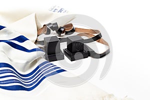 Tallit and tefillin on white background. Jewish ritual objects
