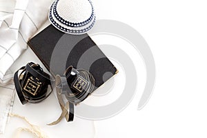 Tallit and tefillin on white background. Jewish ritual objects, prayer vestments