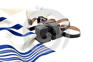 Tallit and tefillin on white background. Space for text