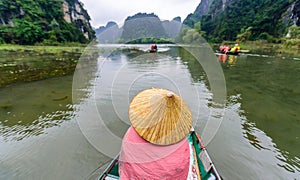 Tam Coc Natioanl Park - Vietnamese Girl traveling in boat along the Ngo Dong River at Ninh Binh Province, Trang An landscape