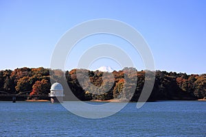 Tama lake and intake tower with Mt. Fuji in autumn