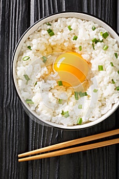 Tamago Kake Gohan Japanese Style Rice With Egg close up in the bowl. Vertical top view