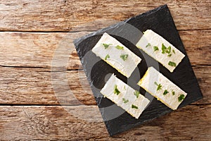 Tamago sando or egg salad sandwiches, are extremely popular in Japan close-up on a slate board. Horizontal top view photo