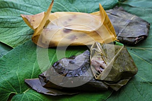 Tamales made with beans wrapped in corn husks and hoja santa leaves photo
