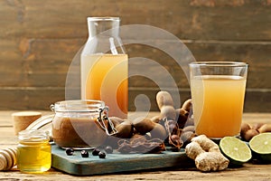Tamarind fruit and drink on rustic table