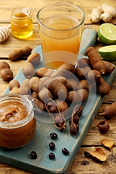Tamarind fruit and drink on rustic table
