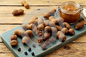 Tamarind fruit and drink on rustic table