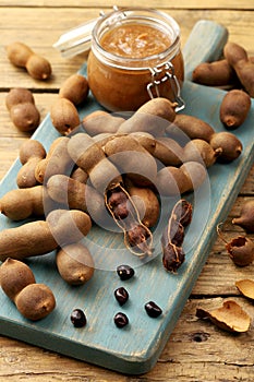 Tamarind fruit and drink on rustic table
