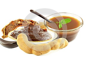 Tamarind with tamarind water juice concentrate chutney pulp or paste on white background