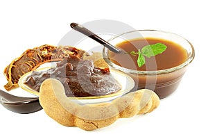 Tamarind with tamarind water juice concentrate chutney pulp or paste on white background photo