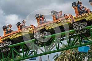 People amazing terrific Cheetah Hunt rollercoaster on lightblue cloudy sky background 49