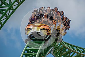 People amazing terrific Cheetah Hunt rollercoaster on lightblue cloudy sky background 58