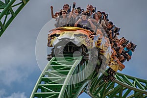 People amazing terrific Cheetah Hunt rollercoaster on lightblue cloudy sky background 54.