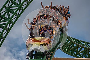 People amazing terrific Cheetah Hunt rollercoaster on lightblue cloudy sky background 55.