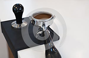 Tamped and compacted coffee grounds in a portafilter