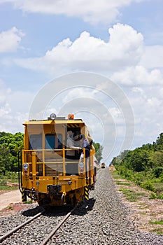 Tamper ballast , tamping machine is building new railway.