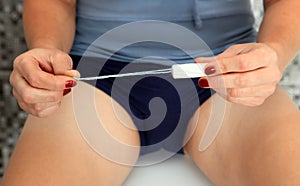 Hands of woman with tampon photo