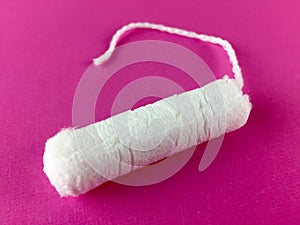 Tampon on a pink surface