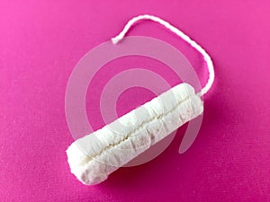 Tampon on a pink surface