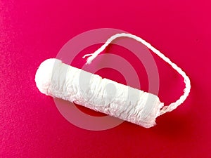 Tampon on a pink surface