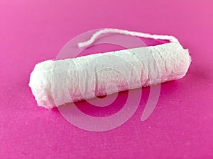 Tampon on a pink surface