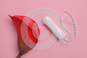 tampon and red flower on pink background