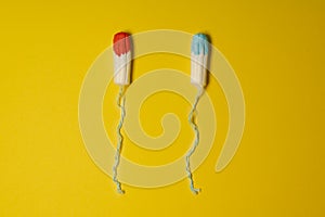 Tampons soaked in blue and red fluid as concept of uncomfortable female truth shown in advertisements for mentruation products