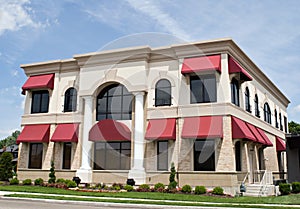 Tan Building with Red Awnings photo