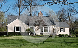 Tan Painted Brick House with Bay Window