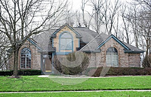 Tan Speckled Brick House with Arched Windows