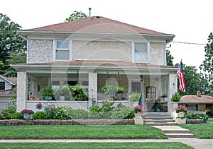 Tan and White Mottled Stucco House with Plants