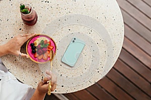 Tan woman chilling and enjoying breakfast during holidays in Bali