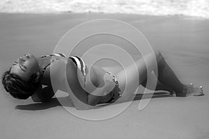 Tan Woman Reclining on a Beach