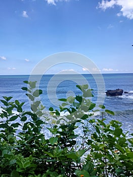 The tanah lot bali indonesia in high tide afternoon