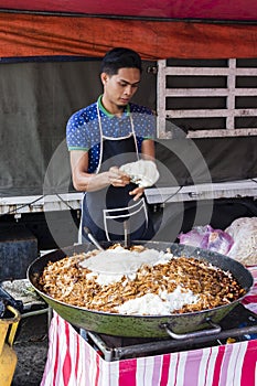 Tanah Rata, Malaysia, December 17 2017: Chef cooks fried noodles