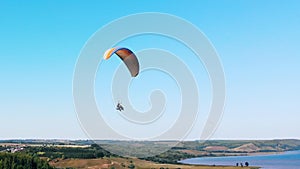 Tandem flight on the paraglider above the fields