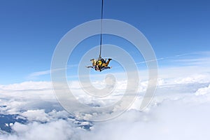 Tandem jump. Skydiving in the blue sky.