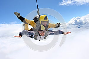 Tandem jump. Skydiving in the blue sky.