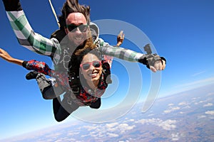 Tandem parachute jump. Beautiful Brazilian woman