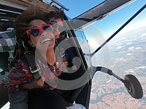 Tandem parachute jump. Beautiful Brazilian woman