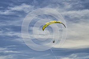 A tandem paraglider and high altitude clouds.