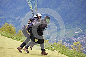 Tandem Paraglider running to Launch