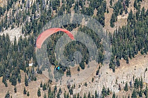 Tandem Paraglider soaring over Grand Teton National Park