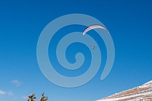 Tandem Paraglider soaring over Grand Teton National Park