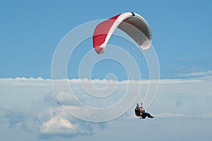 Tandem paragliding high in clouds