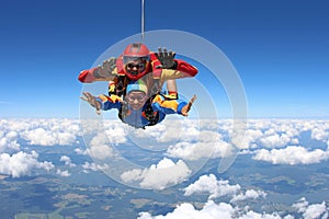 Tandem skydiving. Instructor with sexy girl.