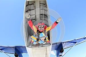 Tandem skydiving. Instructor with sexy girl.