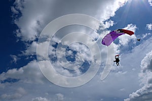 Tandem skydiving. A parachute is landing.