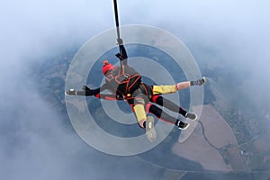 Skydiving. Tandem jump. Man and young woman are falling in the sky together.